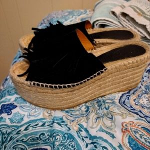 Fringe stacked sandals.